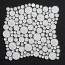 Mosaic tile with circular white stones on a black background