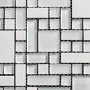 Mosaic pattern of black and white tiles on a white background