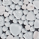 Close-up of white pebble mosaic tiles on a black grid background