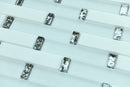 Close-up of small rectangular metallic objects on a white background