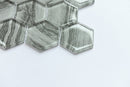 Hexagonal glass tiles with a marble-like pattern on a white background