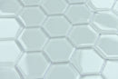 Close-up of hexagonal white tiles with a subtle pattern