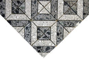 Terrazzo mosaic tile with structured geometric pattern in grey and black tones