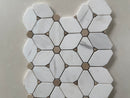 Crystal white marble mosaic with brown dot detailing used as an elegant kitchen backsplash