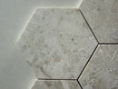 Diana marble hexagon mosaic tile installed on a luxury bathroom floor