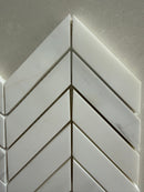 White marble chevron mosaic tile used on a luxury shower wall installation