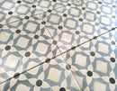 European-inspired decorative porcelain tile floor featuring intricate blue and white motifs