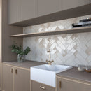 Glossy ivory porcelain tile installed as a kitchen backsplash
