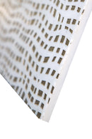 Textured white marble tile with light and shadow highlighting surface depth