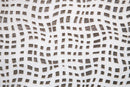 Close-up of textured white marble tile showing layered surface detail