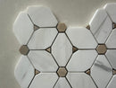 Close up of honed marble mosaic showing crystal white surface with natural brown mineral dot patterns