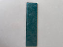 LUX Emerald Green 3x12 glass tile installed on an interior feature wall