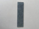 Close-up view of LUX Pewter 3x12 glass tile showing its refined decorative surface
