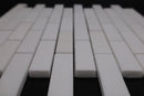 White ceramic tiles arranged in a pattern on a dark background