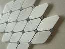 Close up of polished octagon marble mosaic tile showing blue dot inlay and glossy reflective surface