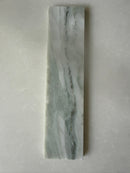 Green marble brick tile by Roca, natural stone 2x10 backsplash tile with elegant veining and smooth surface.