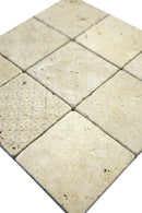 Close-up detail of decorative digital print on tumbled ivory travertine tile