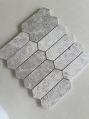 Gray and white natural marble picket mosaic installed on a modern shower wall
